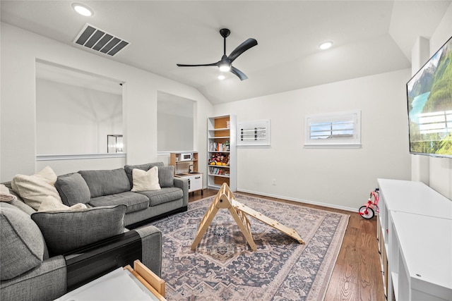 living room featuring lofted ceiling, ceiling fan, and dark hardwood / wood-style flooring