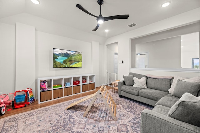 living room featuring ceiling fan, vaulted ceiling, and hardwood / wood-style flooring