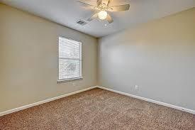 unfurnished room with ceiling fan and carpet floors