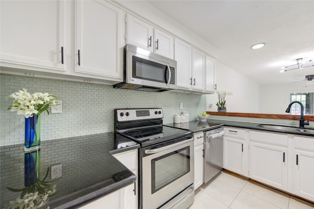 kitchen with sink, light tile patterned floors, tasteful backsplash, white cabinetry, and stainless steel appliances