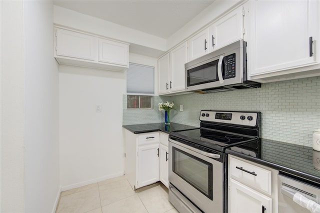 kitchen featuring white cabinets, decorative backsplash, light tile patterned floors, and stainless steel appliances