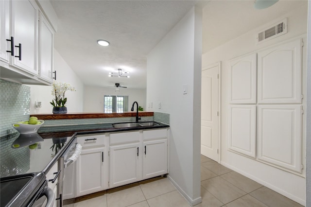 kitchen with white cabinetry, ceiling fan, sink, light tile patterned floors, and range