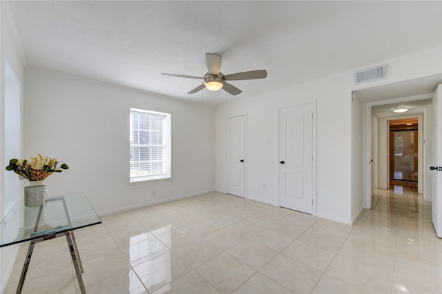 unfurnished bedroom with ceiling fan, light tile patterned flooring, and a textured ceiling