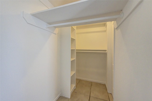 walk in closet featuring light tile patterned flooring