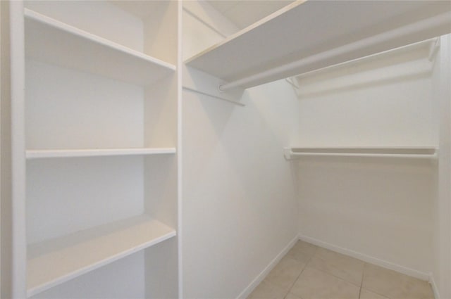 walk in closet with tile patterned floors