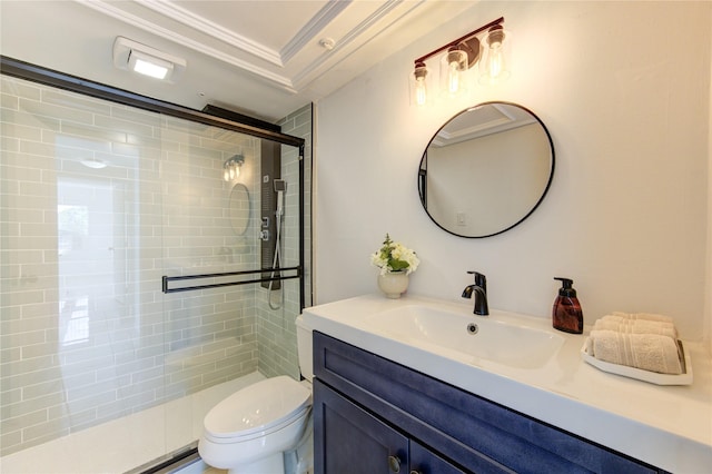 bathroom with vanity, toilet, a shower with door, and crown molding