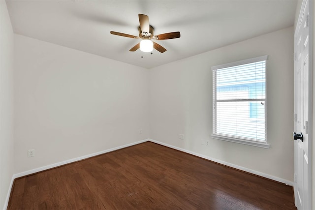 empty room with ceiling fan and dark hardwood / wood-style flooring