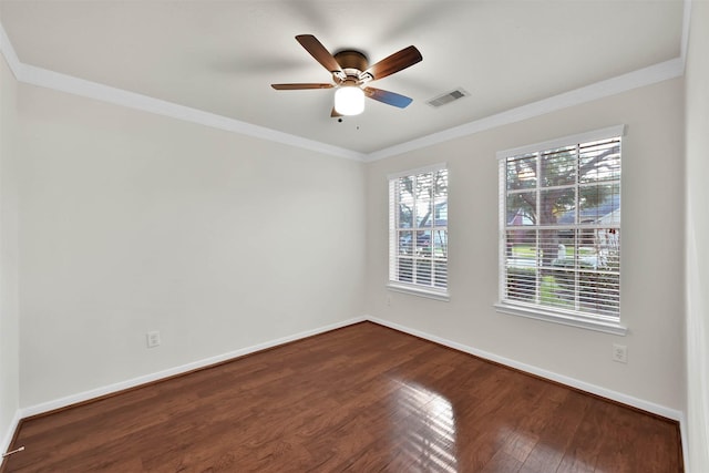 spare room featuring crown molding, plenty of natural light, and wood-type flooring