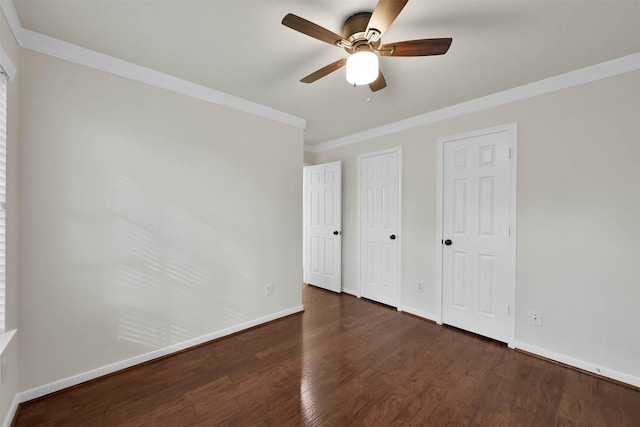 unfurnished bedroom with multiple closets, ceiling fan, dark hardwood / wood-style floors, and ornamental molding