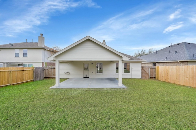 back of property with a patio area and a lawn