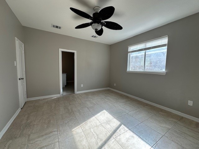 unfurnished bedroom with a spacious closet and ceiling fan