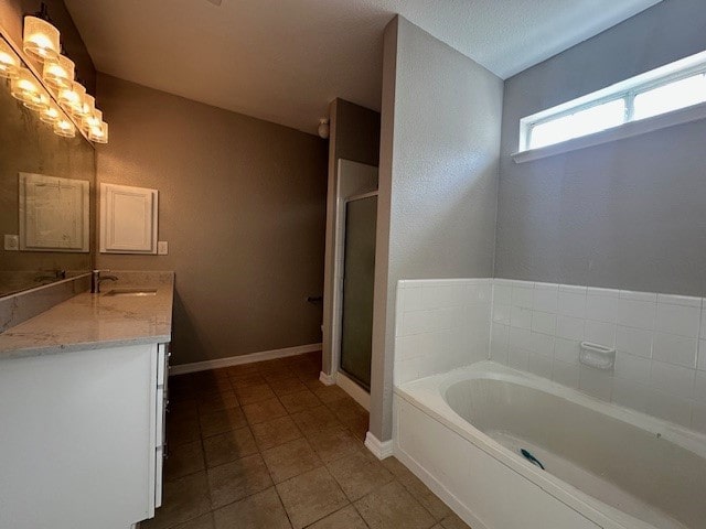 bathroom featuring tile patterned floors, plus walk in shower, and vanity