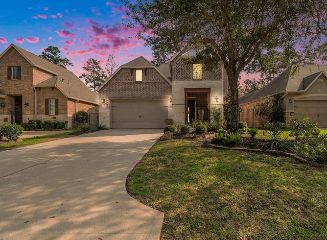 view of front of house with a garage and a lawn