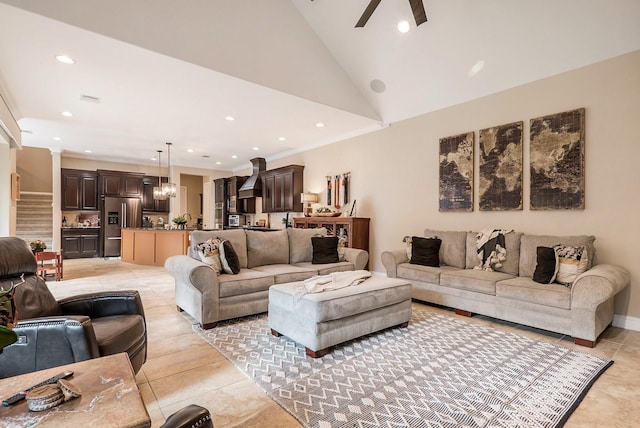 living room featuring lofted ceiling, light tile patterned floors, and ceiling fan with notable chandelier