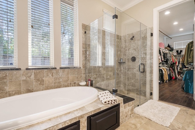 bathroom with separate shower and tub and ornamental molding