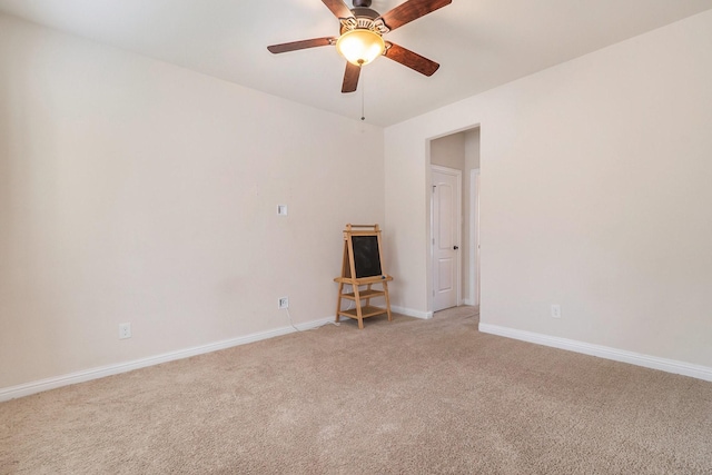 carpeted spare room featuring ceiling fan