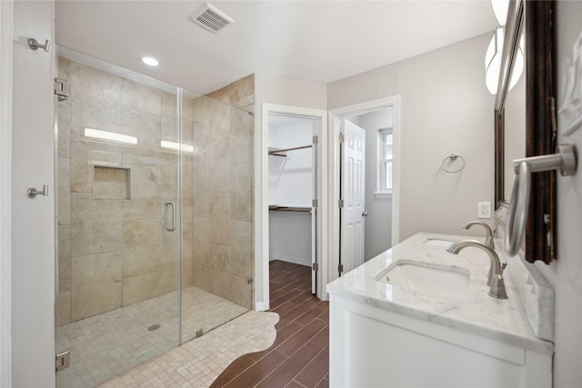 bathroom with vanity and a shower with shower door