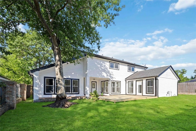 rear view of property with a yard