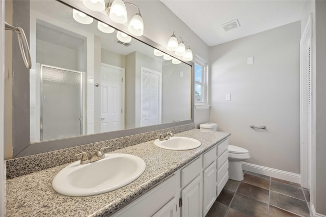 bathroom featuring tile patterned flooring, vanity, toilet, and walk in shower