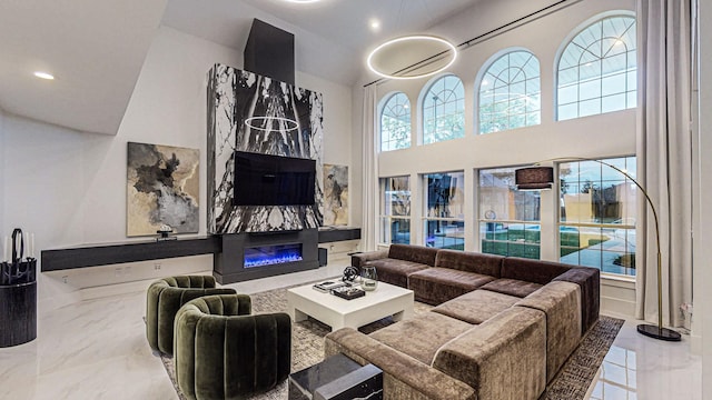 living room with tile patterned flooring and a high end fireplace