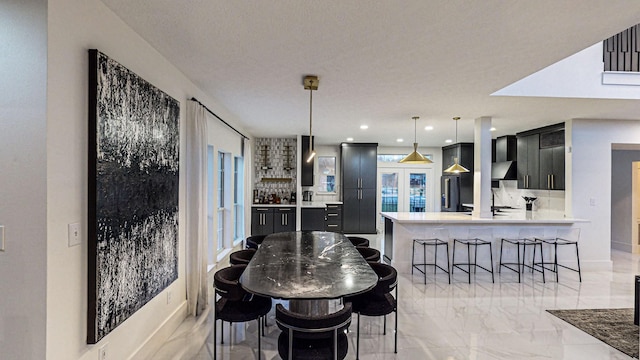 dining room featuring french doors and a textured ceiling