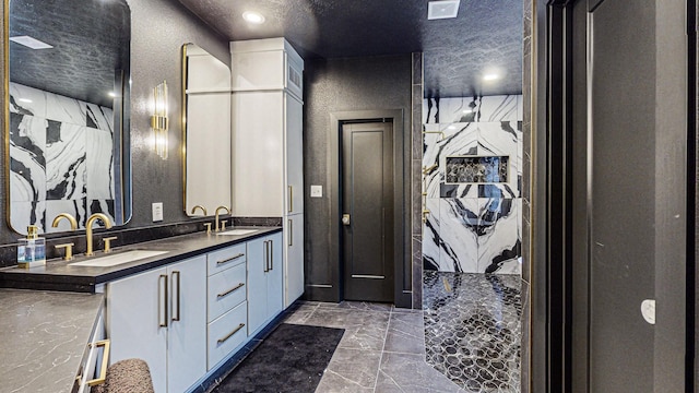 bathroom with vanity and a textured ceiling