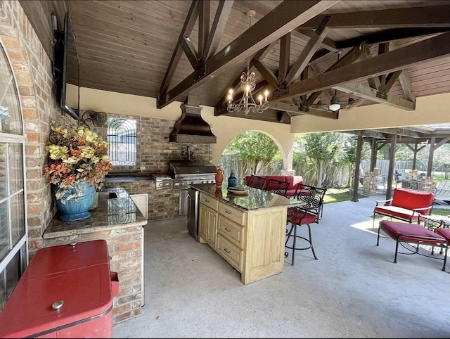 view of patio with ceiling fan, grilling area, a gazebo, area for grilling, and a bar