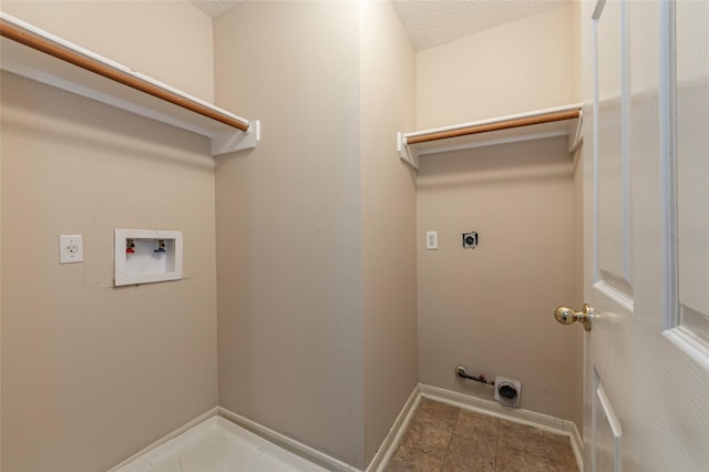 laundry area featuring hookup for a washing machine, a textured ceiling, and hookup for an electric dryer