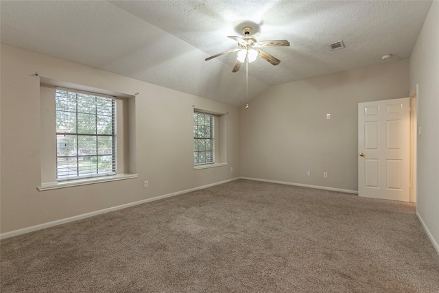 carpeted spare room featuring a textured ceiling, ceiling fan, and lofted ceiling