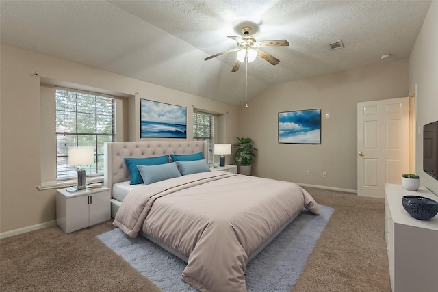 carpeted bedroom featuring a textured ceiling, vaulted ceiling, and ceiling fan