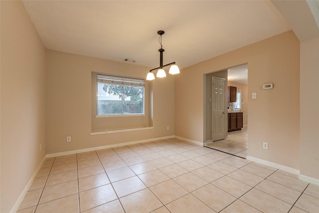 unfurnished dining area with light tile patterned flooring