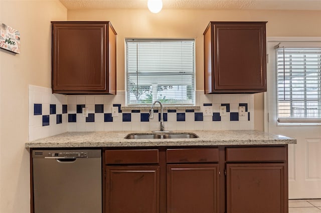 kitchen featuring dishwasher, sink, and a wealth of natural light