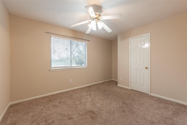 unfurnished room with carpet flooring, a textured ceiling, and ceiling fan