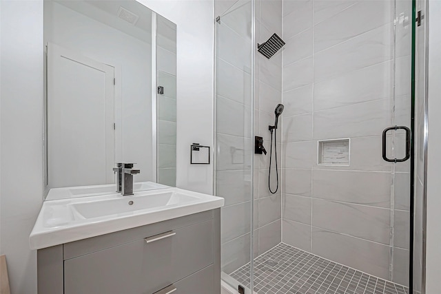 bathroom featuring vanity and a shower with shower door