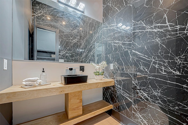 bathroom featuring wood-type flooring, vanity, and tile walls