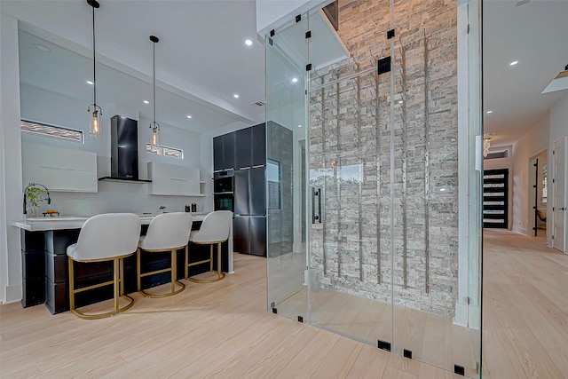 bathroom with a towering ceiling and wood-type flooring