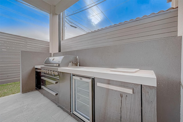 view of patio with beverage cooler and exterior kitchen