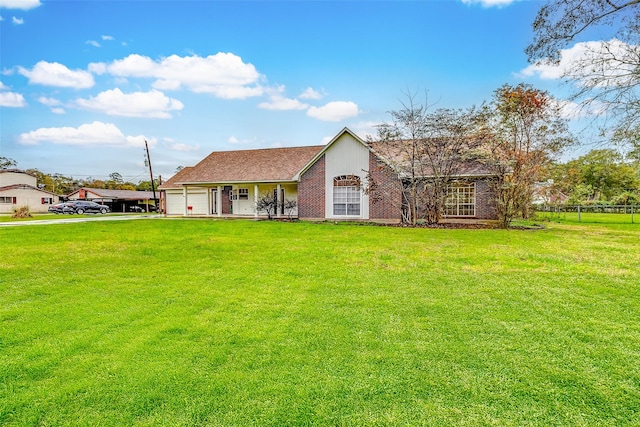 single story home featuring a porch, a garage, and a front yard