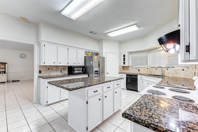 kitchen featuring a kitchen island, backsplash, dark stone countertops, white cabinets, and black appliances