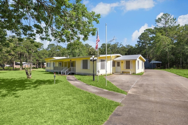 single story home with covered porch and a front yard