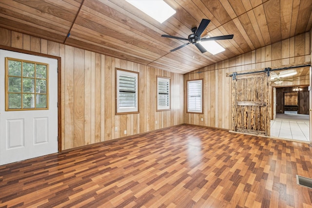 unfurnished living room featuring wood walls, wood ceiling, lofted ceiling, and hardwood / wood-style flooring