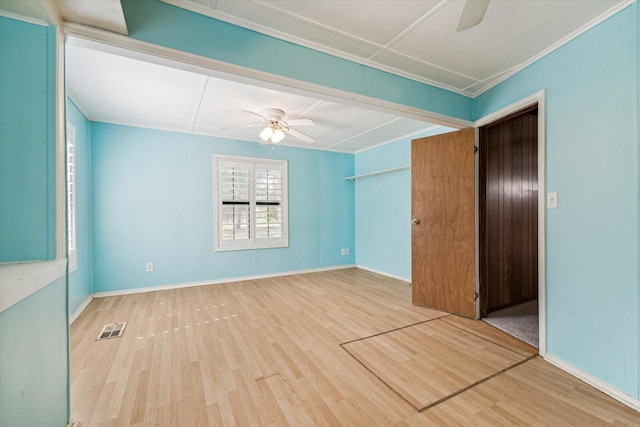 spare room with hardwood / wood-style flooring, ceiling fan, and ornamental molding