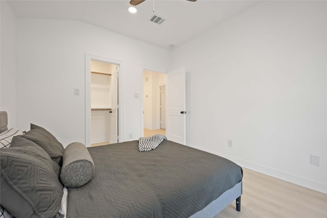 bedroom featuring ceiling fan, lofted ceiling, and light wood-type flooring