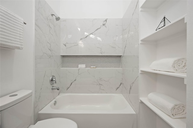 bathroom featuring tiled shower / bath combo and toilet