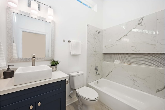 full bathroom featuring vanity, toilet, and tiled shower / bath combo