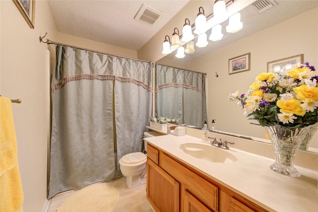 bathroom featuring vanity, curtained shower, toilet, and a textured ceiling