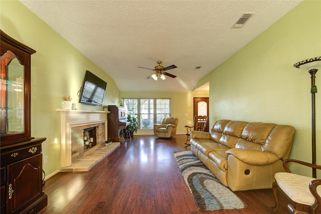 living room featuring a textured ceiling, dark hardwood / wood-style floors, ceiling fan, and lofted ceiling