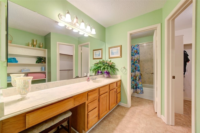 bathroom featuring vanity, a textured ceiling, and shower / bath combo with shower curtain