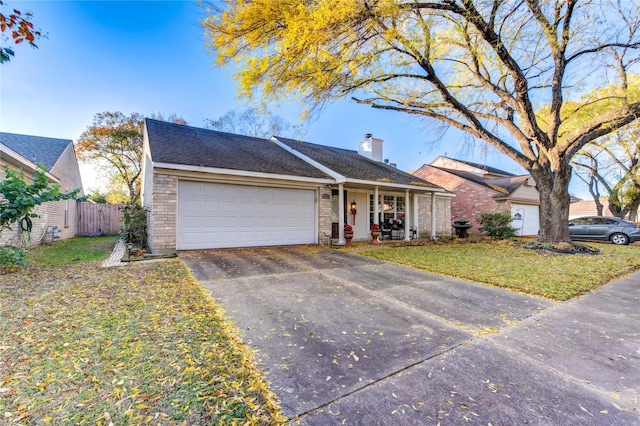 ranch-style home featuring a front yard, a garage, and covered porch