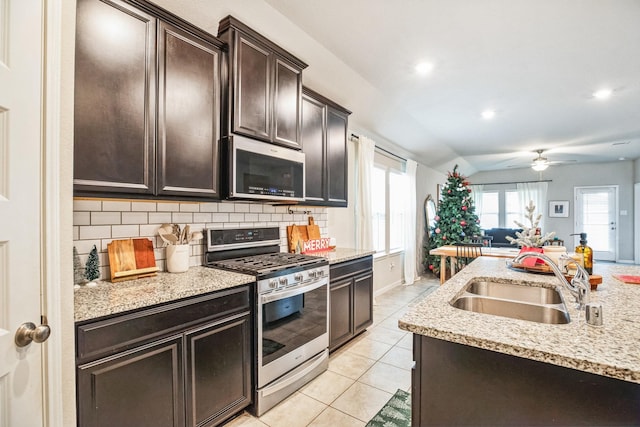 kitchen with decorative backsplash, dark brown cabinets, stainless steel appliances, and sink